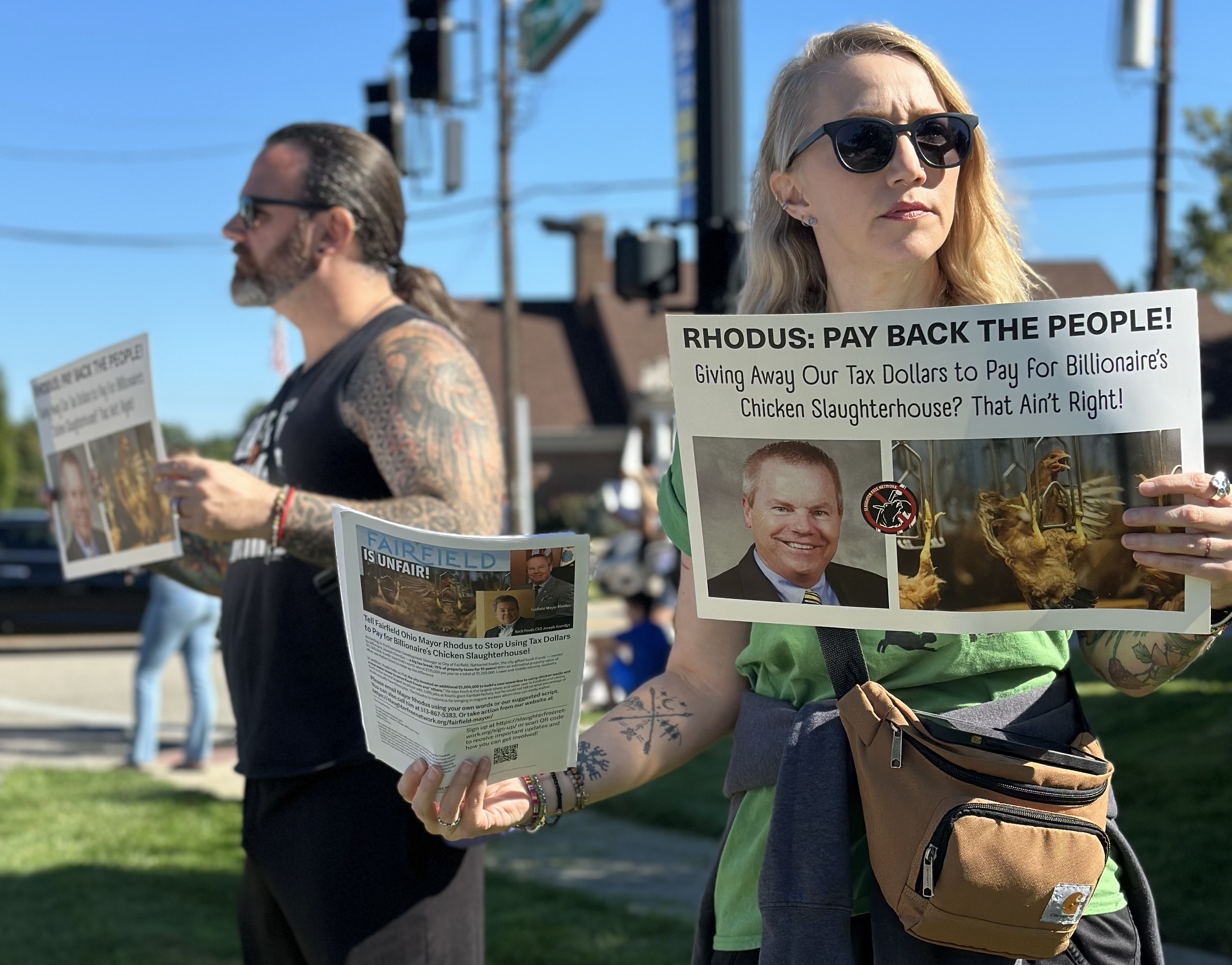 Two people holding signs